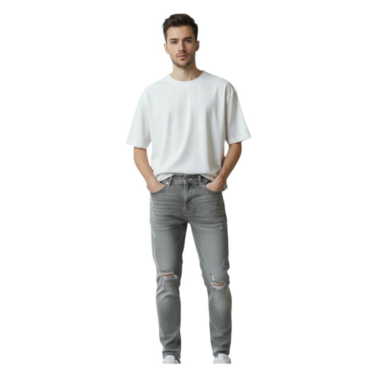 Man wearing a white t-shirt and gray jeans on a white background