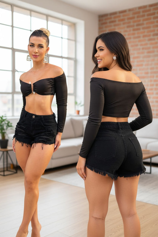 Two women wearing matching black outfits in a modern living room.