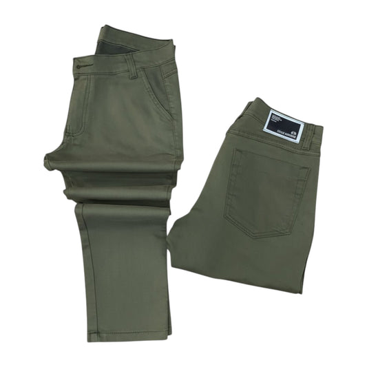 Green pants with a brand label on a white background