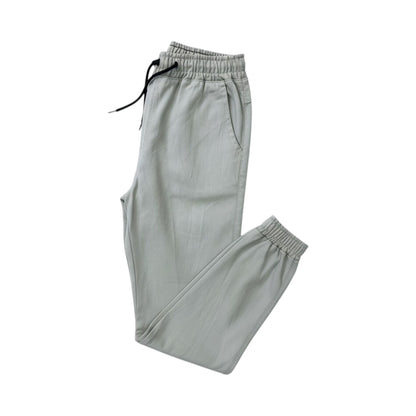 Light gray sweatpants with drawstring on a white background