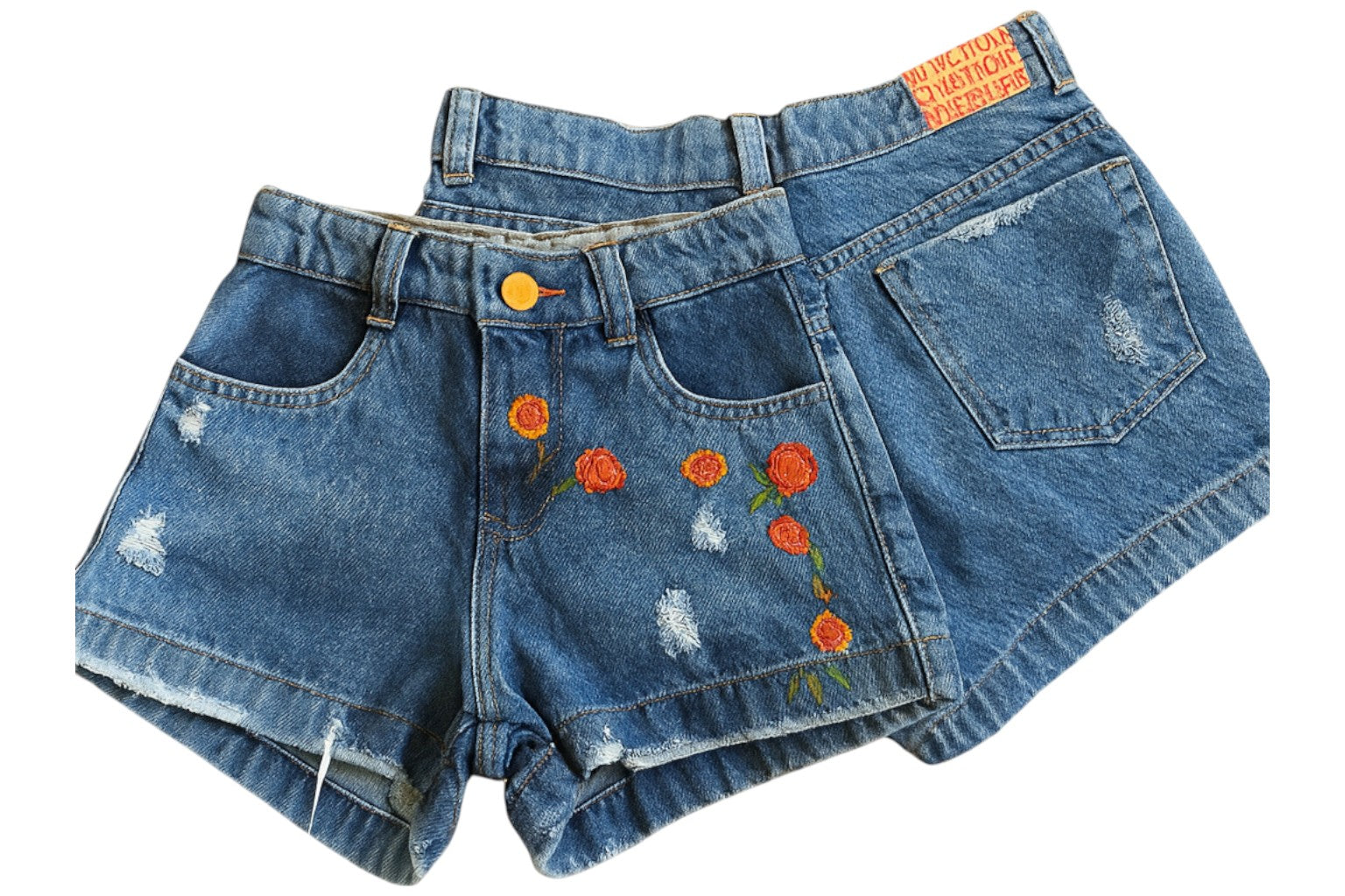 Pair of blue denim shorts with floral embroidery on a white background